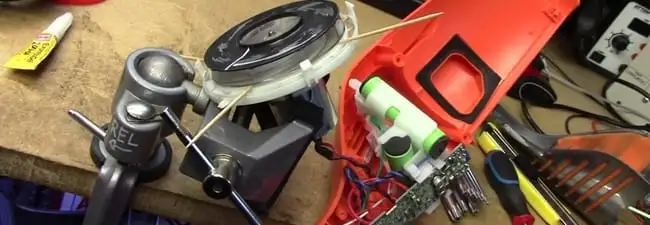 Vacuum cleaner repair parts and tools on a workbench in Columbus, GA