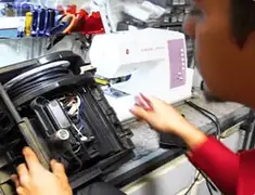 Vacuum repair technician servicing internal components on a workbench in Columbus, GA