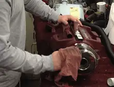 Vacuum repair technician cleaning and servicing a vacuum motor in Columbus, GA